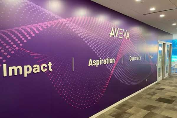 AVEVA office branding wall wrap with purple gradient artwork installed along a corporate corridor
