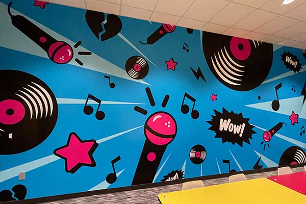 Bold pop-art music-themed wall mural with microphones, records, and stars